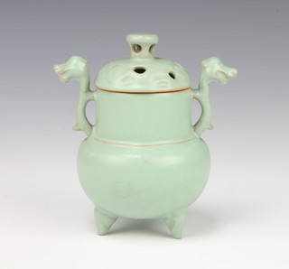 A Chinese Celadon censer and cover with pierced lid and dragon handles raised on 3 feet 13cm 