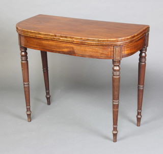 A 19th Century mahogany D shaped card table with ebonised stringing raised on turned supports 75cm h x 92cm w x 45cm d 