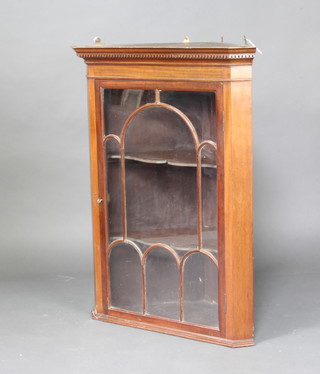 A Georgian style mahogany corner cabinet with moulded and dentil cornice, fitted adjustable shelves enclosed by astragal glazed panelled door 97cm x 73cm x 42cm 