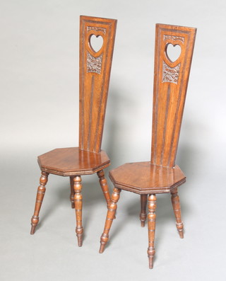 A pair of Victorian carved mahogany spinning chairs the backs marked Mabel and Alice with octagonal seats raised on turned supports 