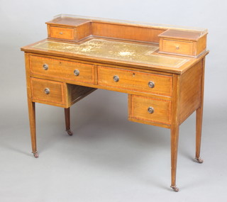 An Edwardian inlaid and crossbanded mahogany writing table, the raised back with brass 3/4 gallery fitted 2 drawers above a leather writing surface, the base fitted 2 long and 2 short drawers, raised on square tapered supports 89cm x 106cm x 46cm  