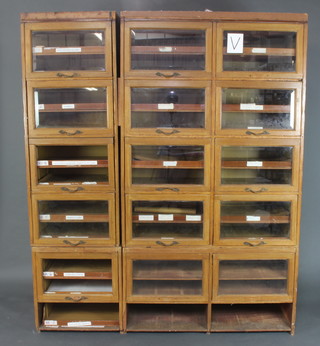 An Edwardian bleached mahogany drapers cabinet fitted 15 sections, each fitted 2 shallow trays enclosed by bevel glazed fall front doors 198cm h x 164cm w x 48cm d 