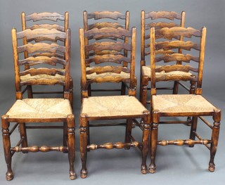 Titmarsh and Goodwin, a set of 6 18th Century style elm ladder back dining chairs with woven rush seats, raised on club supports 