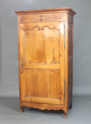 A French 18th Century carved cherry armoire with moulded cornice, shelved interior enclosed by panelled doors, raised on bun feet 205cm h x 111cm w x 62cm d 