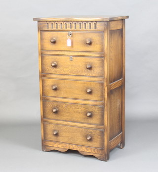 An oak pedestal chest with arcaded decoration fitted 5 long drawers with turned acorn shaped handles 104cm h x 61cm w x 38cm d 
