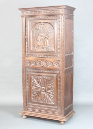 A 19th Century Flemish carved oak cabinet with moulded cornice fitted a cupboard enclosed by a panelled door carved a figure of a lady and gentleman above 1 long drawer, the base fitted a cupboard enclosed by a panelled doors raised on bun feet 73cm h x 79cm w x 44cm d 