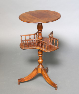 A 19th Century style circular mahogany wine table, the base with triform revolving gallery raised on a pillar and tripod base 76cm h x 43cm diam.  