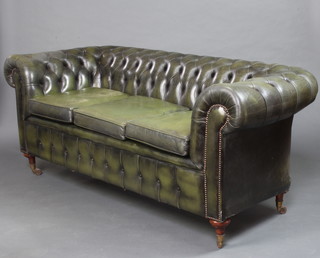 A 3 seat Chesterfield sofa upholstered in green buttoned material 64cm h x 206cm w x 80cm d 
