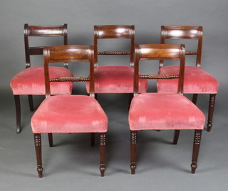 A harlequin set of 5 Georgian mahogany bar back dining chairs with carved rope mid rails and over stuffed seats, raised on sabre supports  