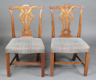 A pair of Chippendale style mahogany slat back dining chairs with overstuffed seats raised on square tapered supports with H framed stretcher