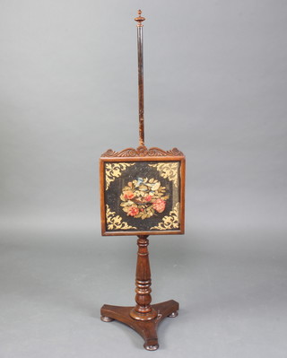 A Victorian rosewood pole screen with turned column raised on a triform base with bun feet with stump work banner decorated a bird 139cm h x 36cm w x 26cm 