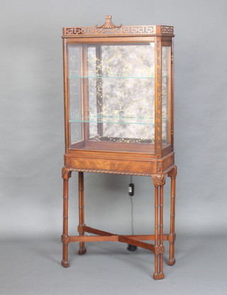 A rectangular Chinese Chippendale style mahogany display cabinet with pierced upper section and blind fretwork frieze, raised on turned supports with X framed stretcher 155cm h x 62cm w x 30cm d  