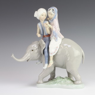 A Lladro group of 2 children on a baby elephant 5352 24cm 