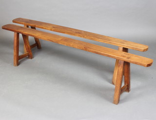 A pair of 19th Century Continental cherry trestle benches 47cm x 200cm l x 15cm w