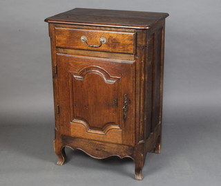 A Continental carved oak cabinet fitted a drawer above cupboard raised on cabriole supports 100cm h x 66cm w x 36cm d 
