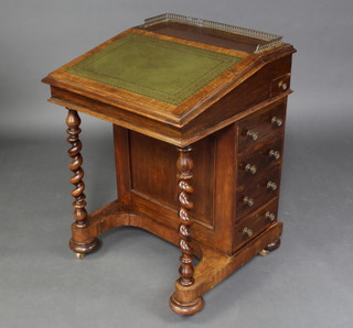A Victorian rosewood Davenport with pierced brass 3/4 gallery with inkwell drawer, fitted 4 drawers, raised on spiral turned supports 82cm h x 59cm w x 59cm 