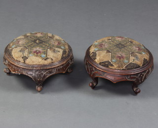 A pair of Victorian circular carved mahogany footstools with bead work covers 11cm h x 26cm diam. 