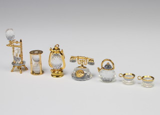 Four Swarovski Crystal memories - lantern, telephone, egg timer, tea set and spinning wheel 
