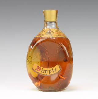 A 26 2/3 fluid ozs Dimple Haig bottle of whisky with outer netting (damage to netting in places) 