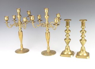 A pair of Victorian brass candlesticks with knopped stems and ejectors 27cm together with a pair of brass 5 light candelabrum 36cm 