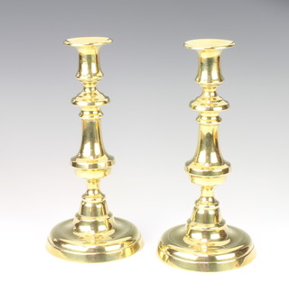 A pair of Victorian polished brass candlesticks with ejectors 25cm 