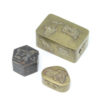 A 19th Century Japanese polished gilt metal shaped trinket box decorated a bird numbered 2cm x 3cm x 2cm base signed, a rectangular ditto 3cm x 6cm x 4cm  and a hexagonal metal box with hinged lid 2cm x 3cm x 3cm 