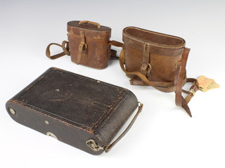 A no.4A folding Kodak Model B camera, a pair of Negretti and Zambra 6 x 24 no.13359 field glasses in a leather case and a pair of 8 lenses field glasses in a leather case 