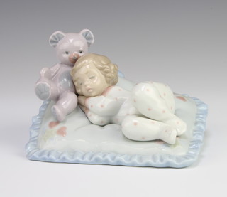 A Lladro figure of a young girl with a teddy sleeping on a pillow 6790 10cm 