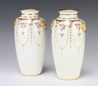 A pair of Mintons oviform vases decorated with roses and gilt swags with drop ring handles 24cm 