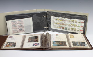 An album of Elizabeth II mint and presentation stamps and an album of first day covers 