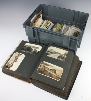 An album containing black and white and coloured postcards and other loose postcards
