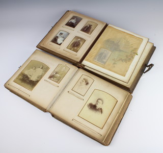 Two Victorian leather bound photograph albums containing black and white photographs (binding damaged) 