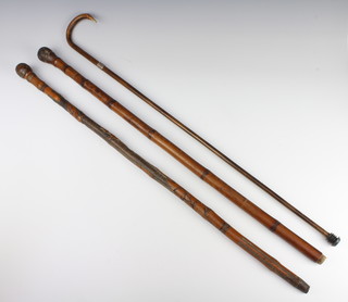 A Chinese bamboo walking cane incorporating an extendable fishing rod (ferrule missing), 1 other carved bamboo cane and a walking cane with silver band (1 band missing) 
