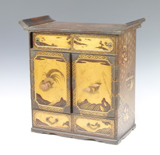 A Meiji period lacquered table top cabinet, fitted 8 drawers enclosed by sliding doors doors, the base fitted 2 drawers 40cm x 40cm x 21cm