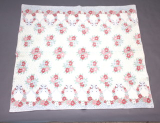 A floral patterned patchwork quilt 188cm x 168cm