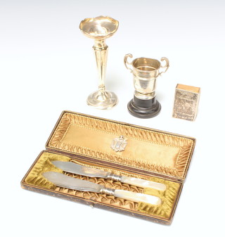 A silver presentation trophy Birmingham 1916 7cm, a spill vase, match sleeve, sports fob and pair of cased plated butter knives 
