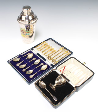 A cased christening set of egg cup and spoon Birmingham 1957, a cocktail shaker, 6 silver tea spoons and 10 gilt teaspoons 