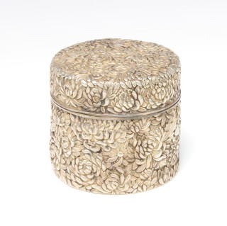A Chinese repousse silver cylindrical jar and cover decorated with chrysanthemums 240 grams