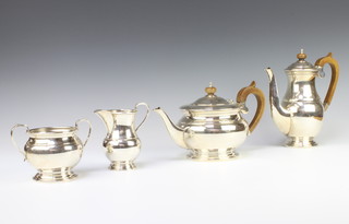 A silver 4 piece tea and coffee set with fruitwood handles, Sheffield 1972, gross weight 1513 grams