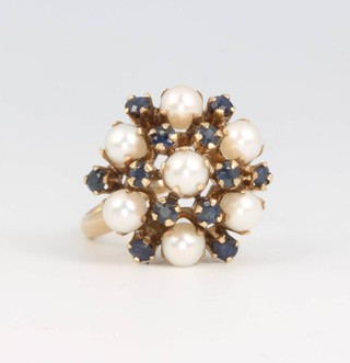 An 18ct yellow gold seed pearl and sapphire cluster ring size O 