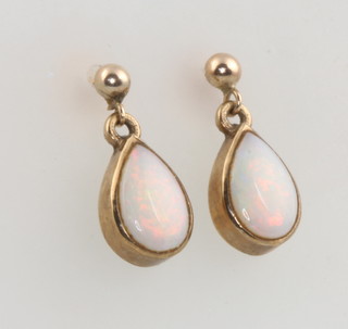 A pair of 9ct yellow gold pear cut opal drop earrings 