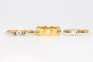 An 18ct yellow gold 3 stone diamond ring size P, an 18ct yellow gold single stone diamond ring size K and a 22ct yellow gold wedding band size J, 3 grams