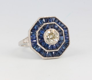 A platinum Art Deco style sapphire and diamond cluster ring, the centre diamond approx. 0.75ct, size N 1/2