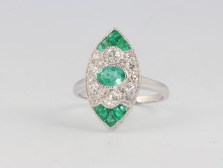 An 18ct white gold marquise cut emerald and diamond ring size M
