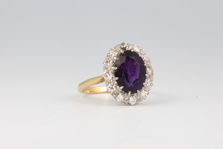 An 18ct yellow gold amethyst and diamond cluster ring size N 1/2
