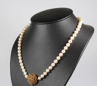 A string of cultured pearls with a 9ct yellow gold ruby set clasp 49cm 