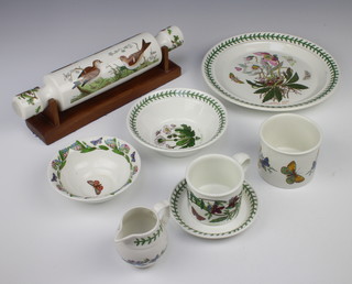 A quantity of Portmeirion Botanic Garden tableware comprising 7 tea cups, 8 saucers, 6 larger saucers, 7 small plates, 6 dinner plates, 6 dessert bowls, slop bowl, cream jug, pot, candle holder, 3 jars, 6 medium plates, 7 soup bowls and a rolling pin 