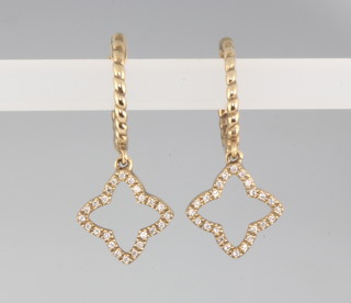 A pair of 9ct yellow gold diamond star shaped earrings 