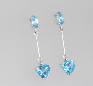 A pair of white gold blue topaz drop earrings with oval and heart cut stones 26mm