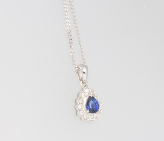 An 18ct white gold pear cut sapphire and diamond pendant on an 18ct chain 15mm 